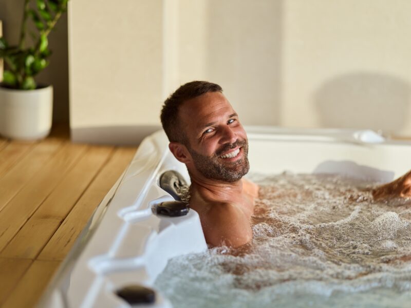 Smiling,Man,Soaking,In,A,Modern,Jacuzzi,Indoors,,Emphasizing,Relaxation